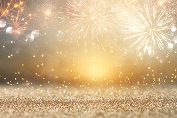 Wall Mural - abstract gold glitter background with fireworks. christmas eve, new year and 4th of july holiday concept.