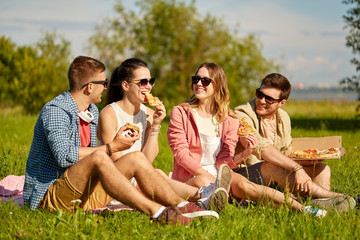 Sticker - friendship, leisure and food concept - group of smiling friends eating pizza at picnic in summer park