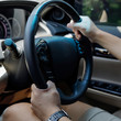 © sutichak - people drive car travel road trip, hand man holding control steering wheel