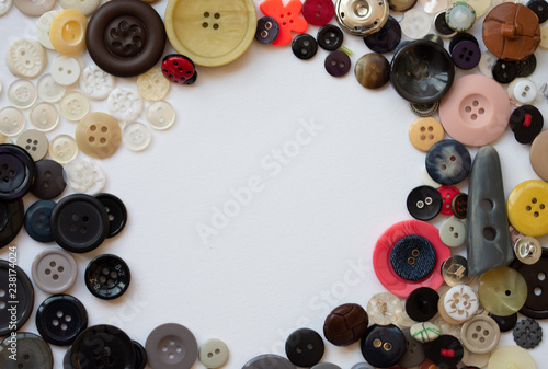 Fotografering Assorted buttons arranged in a circle frame with space for text