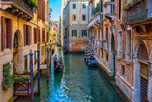 Narrow Canal With Gondola And Bridge In Venice, Italy. Architecture And Landmark Of Venice. Cozy Cityscape Of Venice.