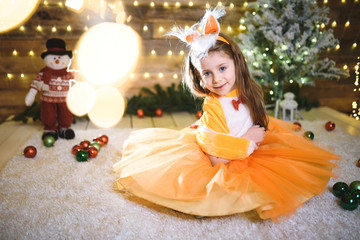 Wall Mural - girl in fox dress sitting in christmas lights