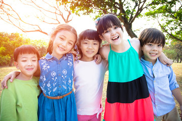 Wall Mural - happy Multi-ethnic group of schoolchildren in park