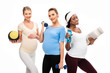 © LIGHTFIELD STUDIOS - three smiling pregnant women holding dumbbells and fitness stuff isolated on white