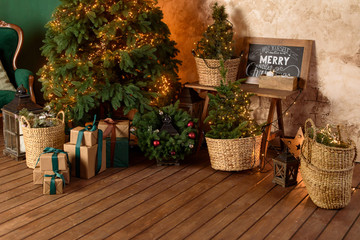 Wall Mural - Christmas tree with lights and gifts in the room on a wooden floor