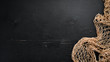 Fishing net on black background. Top view. Free space for your text.
