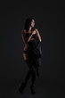 © Vitte Yevhen - Sexy young brunette woman in black sensual lingerie posing on black background wall in studio.