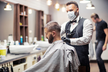 Wall Mural - Hipster man client visiting haidresser and hairstylist in barber shop.