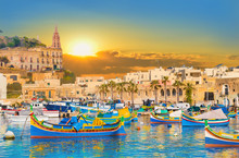 Marsaxlokk Bay Harbour Of Malta, With Beautiful Architecture And Boats At Dusk