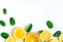White Background With Lemon, Orange Slices And Mint. Concept With Fresh Fruit. Lemon, Orange, Mint. View From Above. Vitamin C