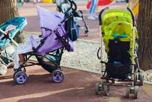 Empty Blue Baby Stroller In A Park - Missing Child Concept.