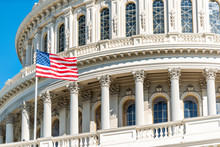US Congress Dome Closeup With American Flag Waving In Washington DC, USA On Capital Capitol Hill, Blue Sky, Columns, Pillars, Nobody