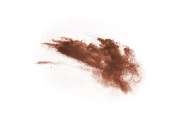 Brown color powder explosion on white background. Colored cloud. Colorful dust explode. Paint Holi.