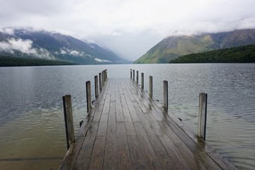  Lake Rotoiti Jetty early in the Morning with Fog lifting off the Mountains, South Island, New Zealand