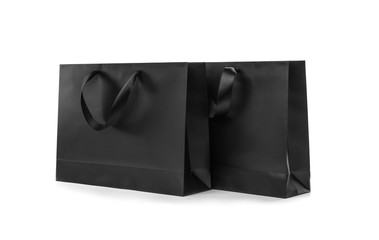 Sticker - Paper shopping bags with ribbon handles on white background. Mockup for design