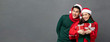 © Atstock Productions - Asian couple wearing colorful red and green sweaters with Christmas gift boxes