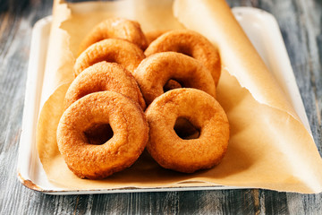 Wall Mural - Homemade donuts  with powdered sugar on a wooden baclground