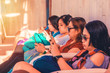 © Dionell - Group of ladies sitting while using their smart phones