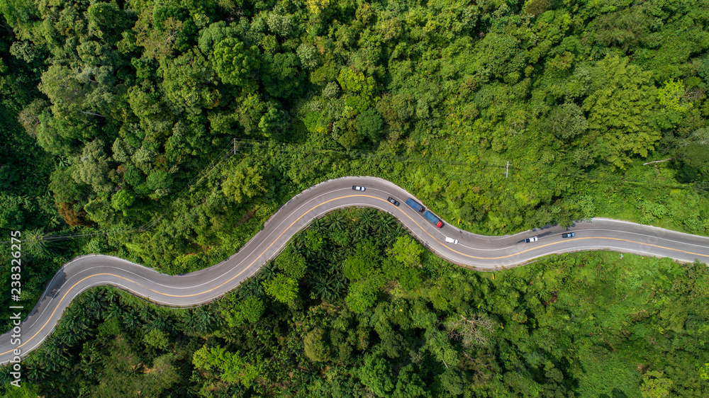 aerial view road curve construction up to mountain - obrazy, fototapety, plakaty 