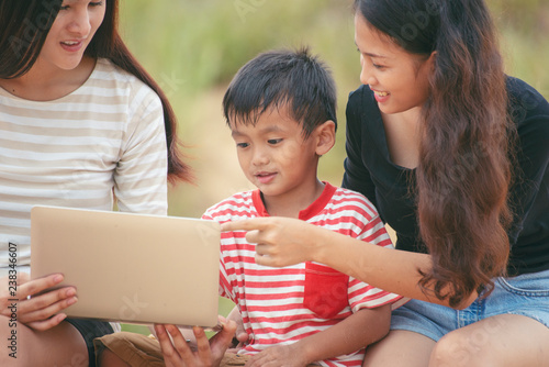 Asian Mother Is Teaching Homework To Dauther With Laptop