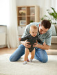 © Syda Productions - family, toddling and fatherhood concept - father helping little baby daughter with walking at home