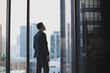 © ReeldealHD images - Businessman looking up at skyscraper thinking