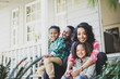 © ReeldealHD images - Smiling family sitting outdoors