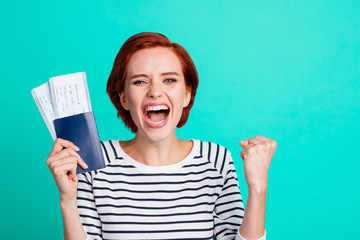 Yeah hooray! Close up photo headshot portrait of cheerful smiling celebrating with open mouth mad cool she her lady gesturing raise fist hand showing two train tickets isolated turquoise background