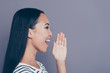 © deagreez - Close up side profile photo of amazing charming attractive she her girl gladly yelling to empty space broadcasting some news wearing white striped pullover isolated on grey background