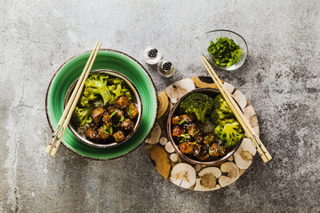 Wall Mural - Basmati rice with tofu in General Tso sauce and steamed broccoli. full healthy vegetarian lunch or dinner on a stone table