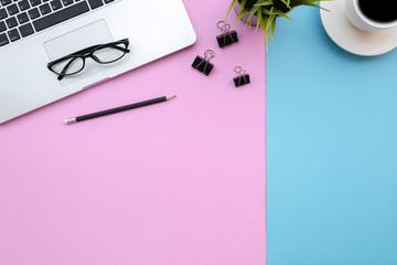 Wall Mural - Flat lay of top view modern desk blue&pink pastel color tone work table with computer laptop and stationary in home office includes copyspace for add text or graphic