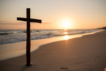 A Christian Holy Cross Standing On The Horizon Of Light And Sea