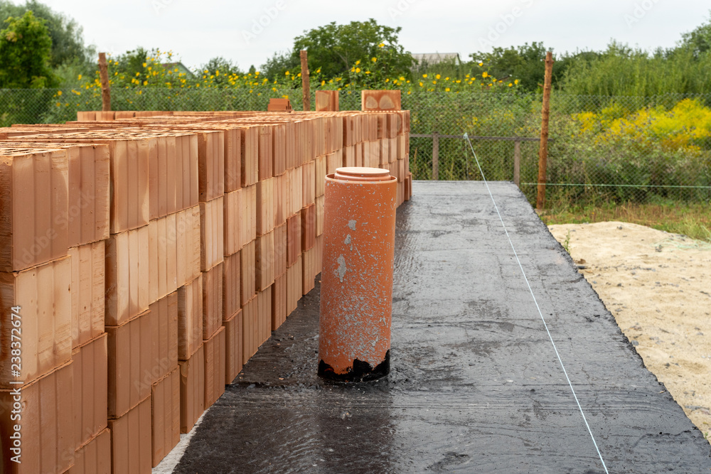 Bitumen Bricks House construction concept. Close up photo of new brick wall with mark ...