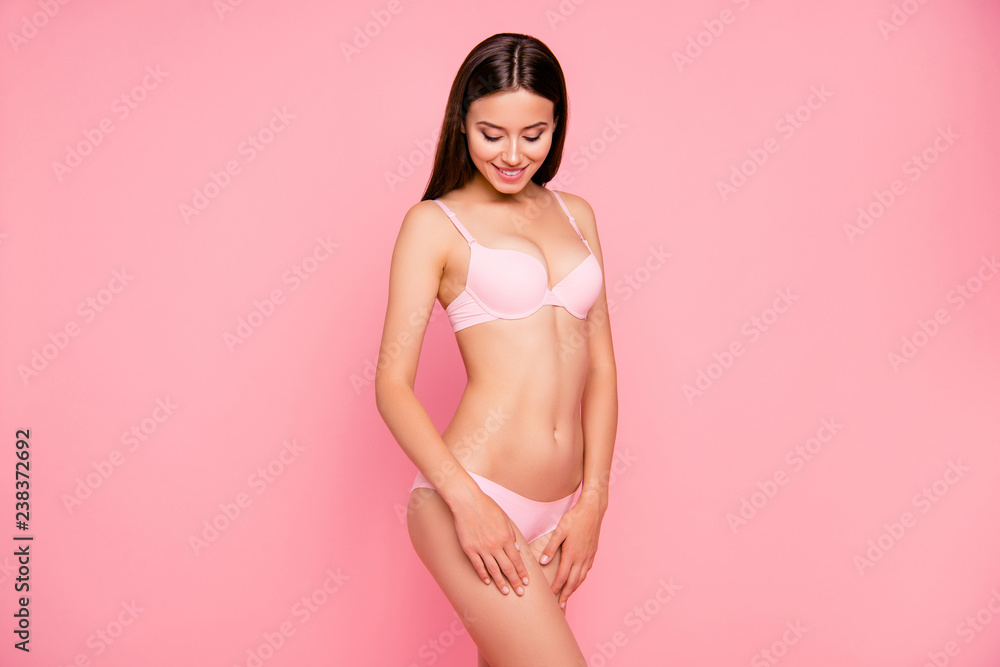 Close up portrait of attractive beautiful gorgeous gentle her she girl standing gladly touching perfect legs after anticellulite procedure wearing pale pink underwear isolated on pink background - obrazy, fototapety, plakaty 