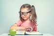 © Myst - beautiful cute little girl reading and turning the pages of thick book