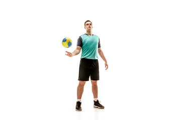 The fit caucasian young male handball player at studio on white background