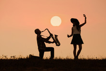 Musician Play Saxophone With Sunset Or Sunrise Background
