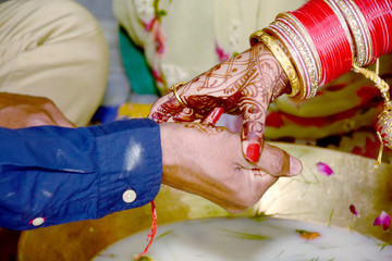 Wall Mural - Indian couple playing Ring Fishing game in wedding ceremony of India