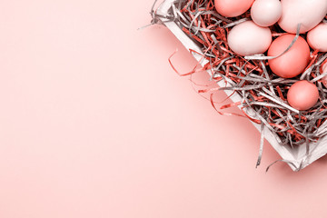 Wall Mural - Eggs in a white tray. Creative Easter concept. Modern solid pink background.  . Living coral theme - color of the year 2019