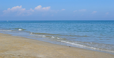 Landscape of sandy beach and light storm on the sea, background