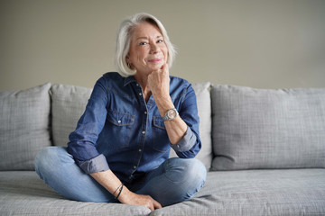 Wall Mural - Modern senior woman in all denim on couch