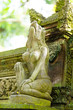 Long-tailed macaque monkeys roam free amongst the balinese Hindu temples of the sacred Ubud Forest in Bali, Indonesia.
