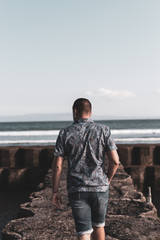 Wall Mural - Young man on a seaside background, Bali island.