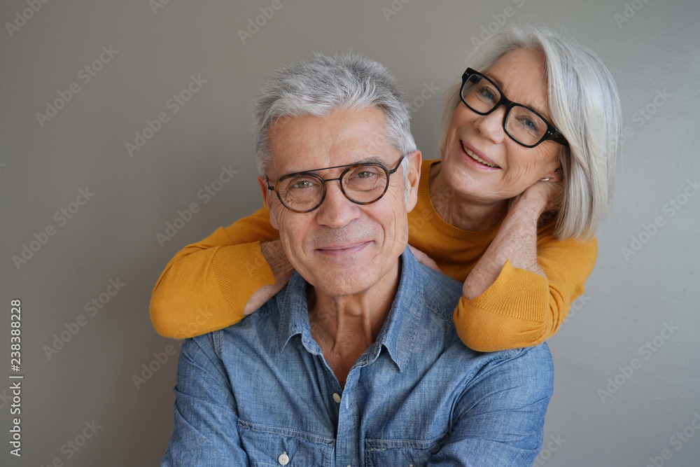  Portrait of relaxed fun senior couple wearing glasses on background - obrazy, fototapety, plakaty 