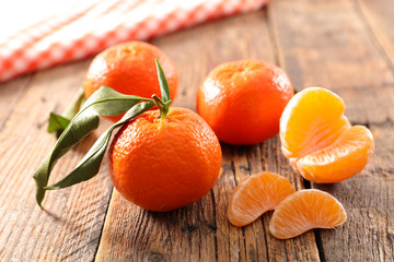 Wall Mural - clementine fruit on wood background