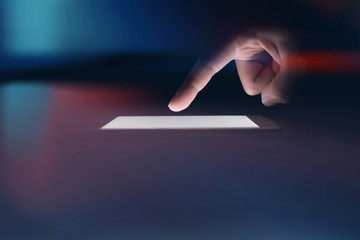Image Businessman is using technology on a phone in a dark room.