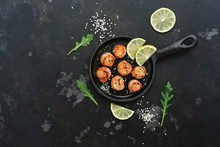 Scallops Fried In A Pan With Lemon, On A Black Stone Background. Top View, Copy Space.