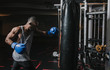 © ADDICTIVE STOCK - African American boxer training in gym