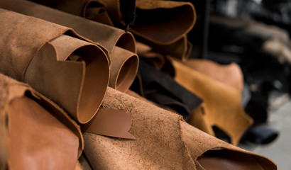 different pieces of leather in a rolls. the pieces of the colored leathers. rolls of natural brown r