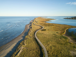 Wall Mural - Aerial view of a beautiful sandy beach on the Atlantic Ocean Coast. Taken in La Dune de Bouctouche, New Brunswick, Canada.